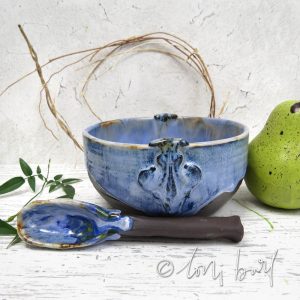 blue and chocolate clay ceramic bowl with ceramic spoon