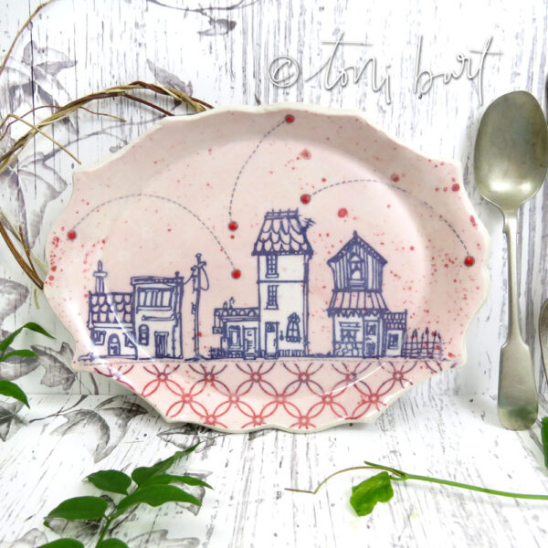 handmade scalloped edge plate with houses